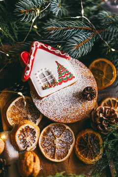 Gingerbread house cookie with Christmas decoration and festive food