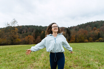Woman enjoying mindful movement in nature for wellbeing