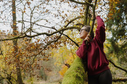 Thoughtful woman finding balance and mindfulness in the autumn forest