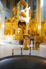 Golden altar with candles in a quiet temple interior