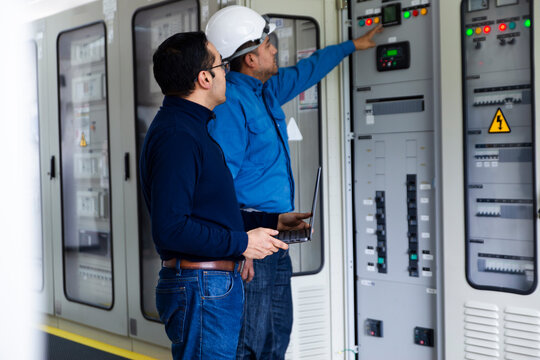 Engineers monitoring electrical systems in a substation control room
