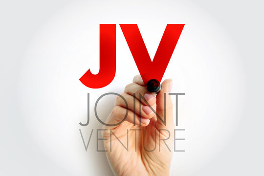 JV Joint Venture acronym written by hand. Business collaboration and partnership concept representing cooperation between companies for shared objectives and project development