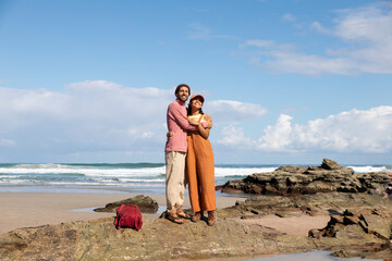 Couple embracing on rocky beach at Playa de las Catedrales Galicia