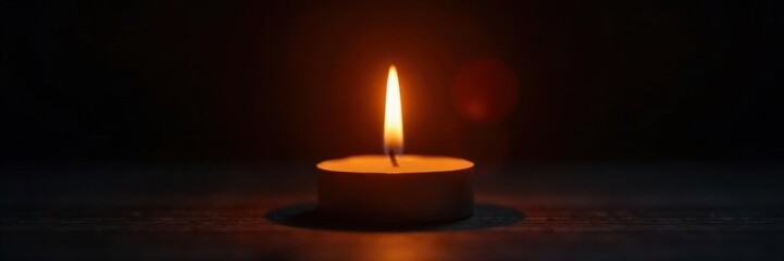 Single candle flame illuminates dark room, warm glow , home, night