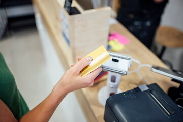 Customer using credit card for payment at retail store checkout