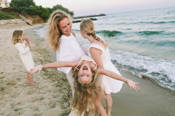 Family playing joyfully on the beach showing playfulness and bonding
