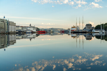 Sunrise reflection at historic harbor in Bergen Norway with tranquil water