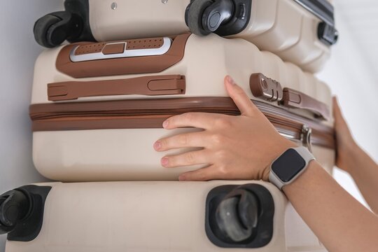 Hands packing minimalist luggage for organized travel planning