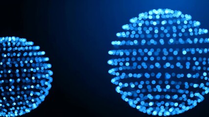 Two blue glowing spheres composed of light particles stand out against a dark backdrop, illuminated with a soft blue light. Abstract design ideal for conveying technology, data or futuristic concepts.
