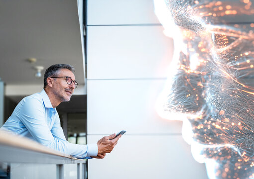 Engineer using tablet to chat with AI bot in modern workspace