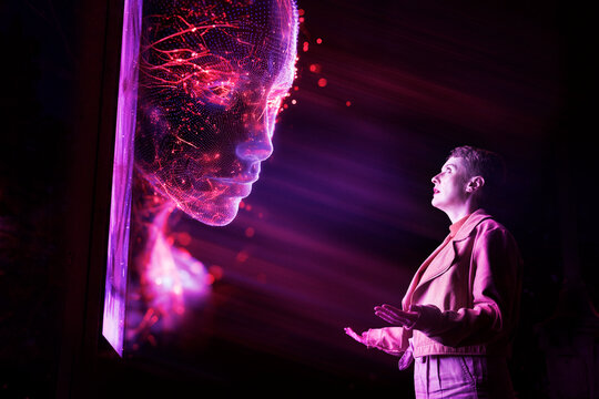 Engineer interacting with glowing artificial intelligence hologram