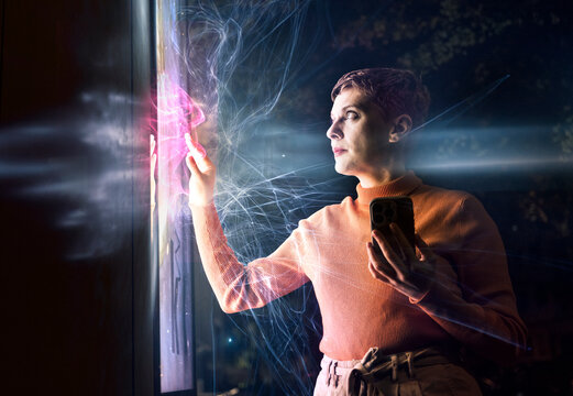 Engineer interacting with touch screen tablet and AI technology at night