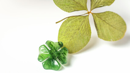 Detail of two four-leaf clovers on background