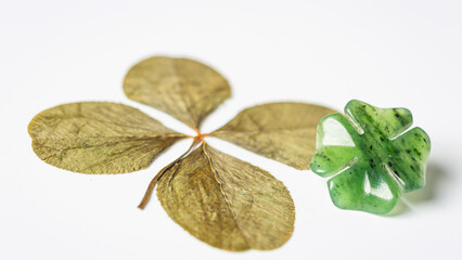 Detail of four-leaf clovers on background