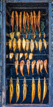 Various smoked fish hanging in smokehouse in Wismar Germany