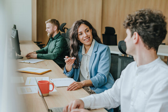 Colleagues discussing work in a modern office setting