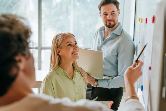 Business colleagues discussing and planning at board in office - Powered by Adobe