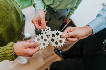 Business team collaborating with gears symbolizing teamwork in office
