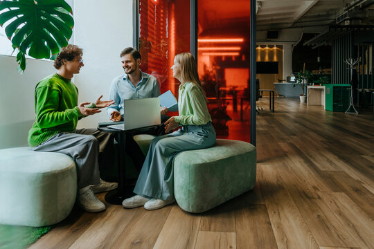 Colleagues discussing a business project at a modern office meeting
