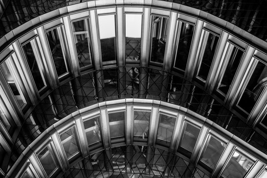 Symmetry and geometry enhancing a modern architecture facade marked by strong structure, reflection, minimalism, unified urban design and distinctive architectural detail