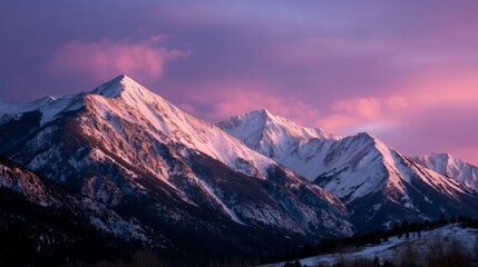 Stunning mountain range at sunset with vibrant purple and pink skies