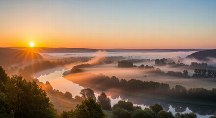 Dawn's Embrace: Witness the tranquil beauty of a misty river valley as dawn gently unveils a breathtaking landscape, where the sun kisses the horizon, painting the sky with warm hues.