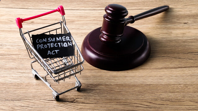 Consumer Protection Act concept with a judge's gavel and a miniature shopping cart, symbolizing buyer rights and legal regulation in commerce.