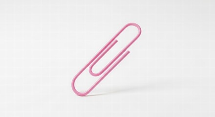 Vibrant Clip: A single, pink paper clip, a simple yet essential tool for organization and efficiency, isolated against a soft backdrop. 