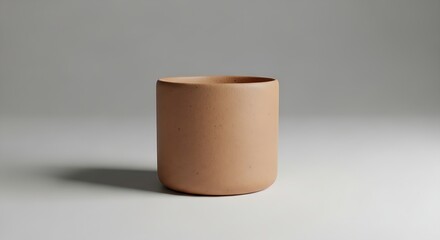Simple handcrafted clay cup with natural earthy tones, minimalist studio lighting, rustic handmade pottery for lifestyle and product design.