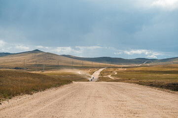 an empty country road on Olkhon Island with dramatic clouds in the sky