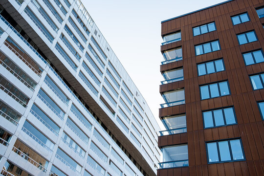 Contemporary housing architecture with linear facade rhythm and bright contrast underpinning modern minimalism across the urban development of Liljeholmen Stockholm