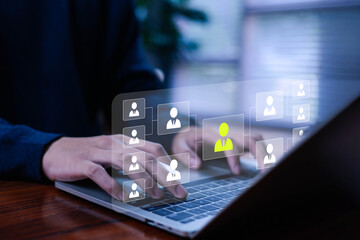 Business professional using a laptop with futuristic HR interface showing talent selection icons, highlighting digital recruitment, employee management, and modern human resources technology.