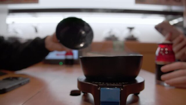 Person opening steaming hot miso soup bowl