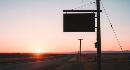 Dramatic Sunset Over Rural Road With Signboard Silhouette Against The Orange Sky
