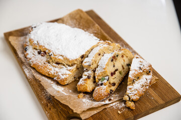 A Christmas stollen on wooden cutting board