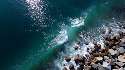 Waves crashing on rocky shore at seaside during sunny day