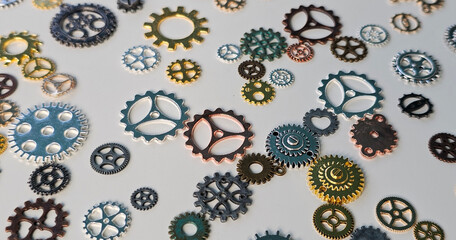 Various metal gears from a disassembled device. Randomly scattered parts from mechanisms concept