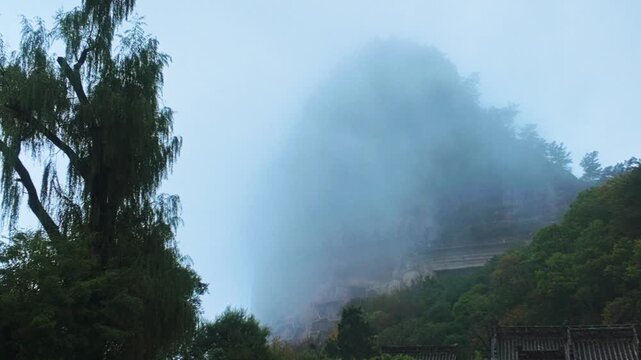 Foggy Clouds At Tianshui Maiji Mountains In Gansu Province, China. Wide Shot