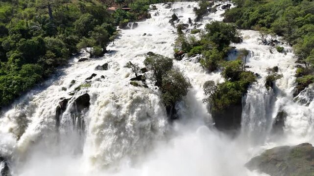 Drone panorama Binga Falls, Angola, capturing the multi-level cascades and thick vegetation surrounding the rushing Kwanza River in stunning aerial detail Africa footage