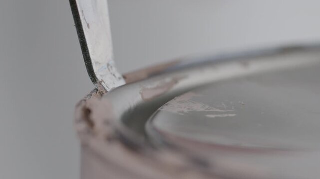High Quality Video of a close-up of opening a Farrow and Ball paint can. Close-up showcasing the start of a painting project with premium materials.