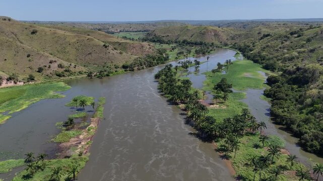 erial drone footage of the Kwanza River through lush green landscape near Binga Falls in Angola, capturing nature and tropical wilderness from above