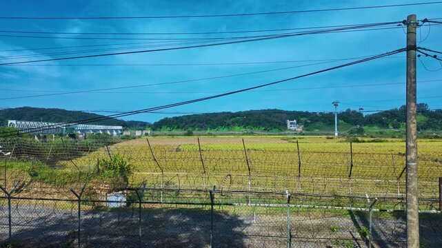Barbed Wire Fencing At The Korean Demilitarized Zone (DMZ) Bordering North And South Korea. Panning Shot