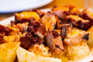 Galician-style octopus with potatoes, (polbo á feira con cachelos), a traditional Galician dish,...