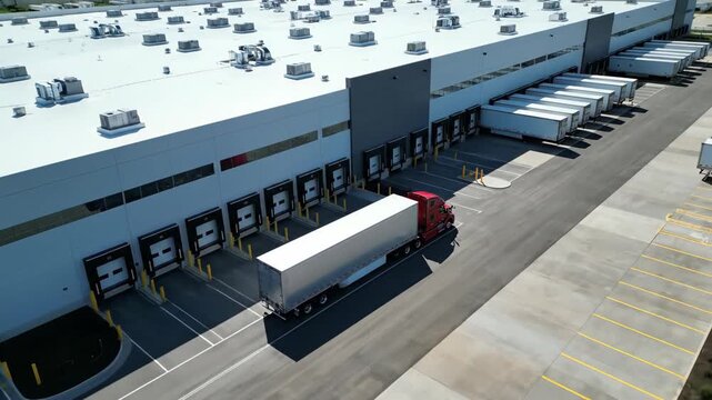 Semi Truck Arrives at Distribution Center Loading Dock During the Day