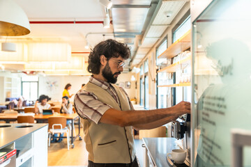 Man preparing coffee in modern coworking office