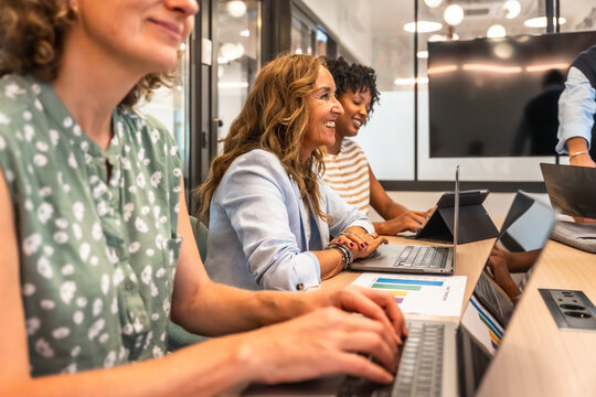 Diverse businesswomen collaborating and working in modern office