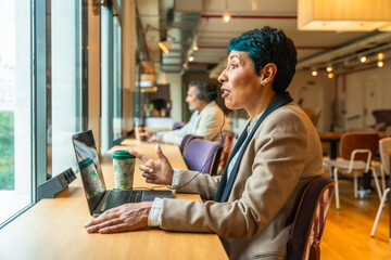 Businesswoman having video call in coworking office space