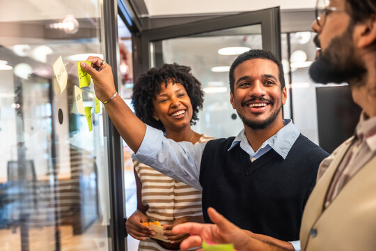 Diverse business team brainstorming ideas using sticky notes