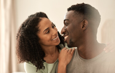 Loving multiracial couple looking at each other and smiling