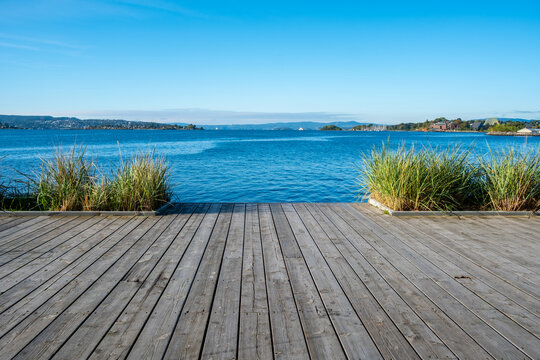 Open public space around water blending greenery with urban landscape architecture in Oslo Norway promoting river edge character for urban design centric messaging